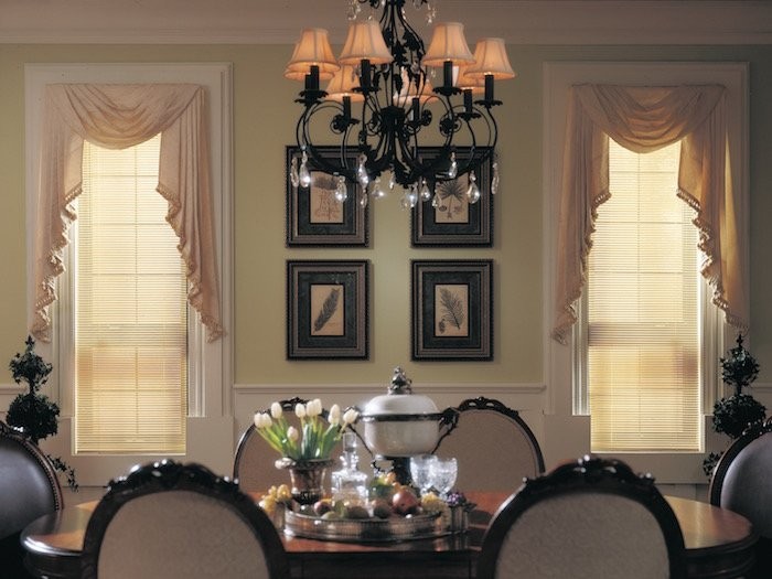 Traditional dinning room with custom drapes and fancy chandler